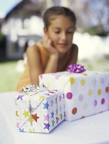 Girl (9-11) looking at gifts, close up