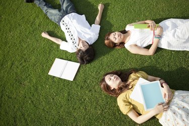 Young people lying down on grass