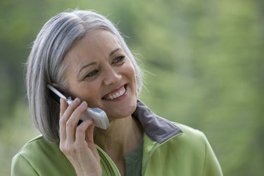 Close-up of mature man talking on mobile phone outdoors