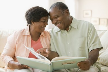 Senior African couple looking at photo album