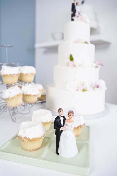 Wedding cake, cupcakes, and wedding figurines