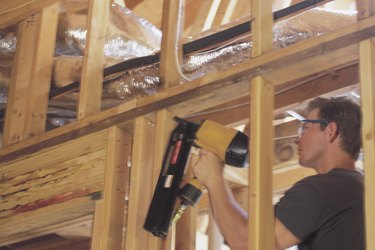 Carpenter using nail gun