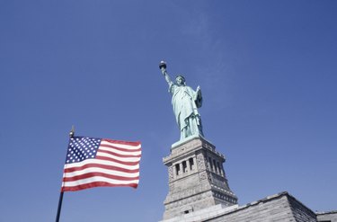 American flag and Statue of Liberty, New York, USA, (Low angle view)
