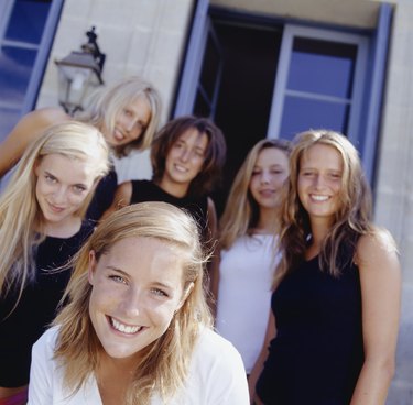 Group of young women standing in front of house, portrait