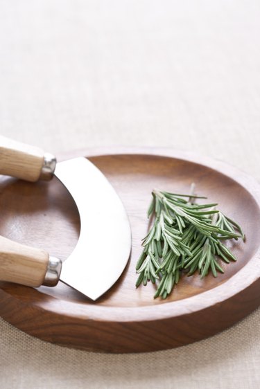 Rosemary in herb chopping board