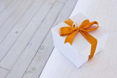 White gift with a red ribbon