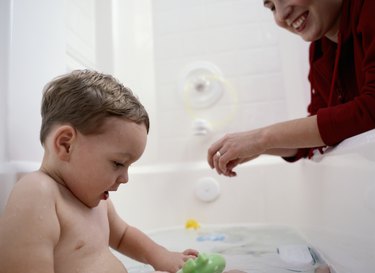Mother Bathing Young Son