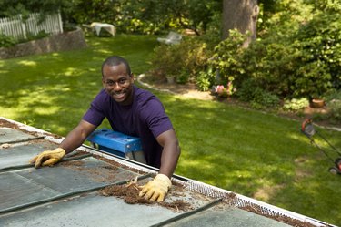 man cleaning gutters