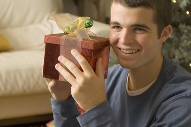 Teenage boy holding Christmas present