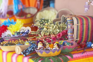 Dolls and artificial flowers on table in a store