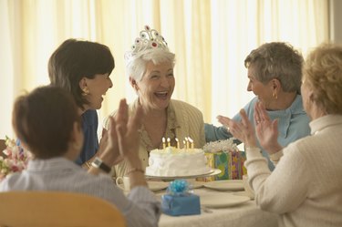 Senior woman celebrating birthday with friends