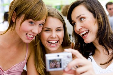 Women taking photograph with digital camera