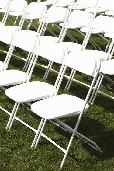 White folding chairs in rows