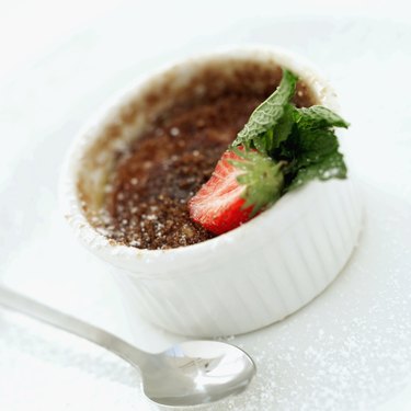 Close-up of a bowl of pudding with a strawberry garnish