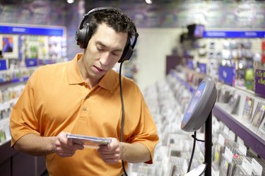 Man sampling music in a record store