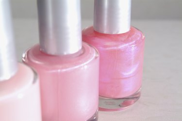 Close-up of three bottles of pink nail polish