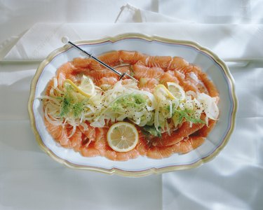 Salmon with vegetable salad on plate, close-up