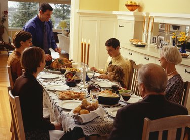 Family carving thanksgiving dinner