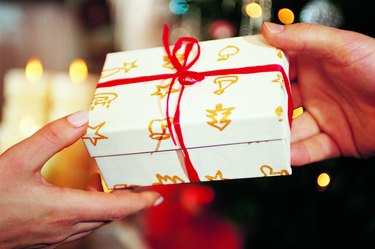 Close-Up of Present Being Handed Over at Christmas