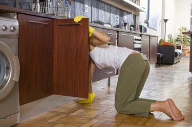 Woman cleaning in kitchen