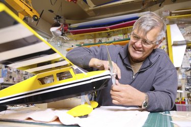 Senior man working on model airplane