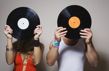 People holding vinyl records