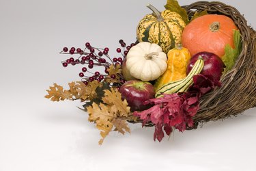 Cornucopia of winter squash and autumn leaves