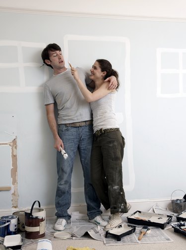 Couple playing around with house paint