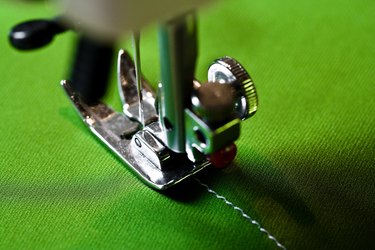 Sewing machine on green fabric