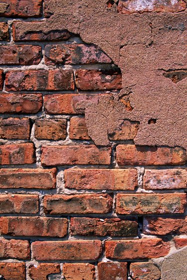 Brick wall with cracked plaster