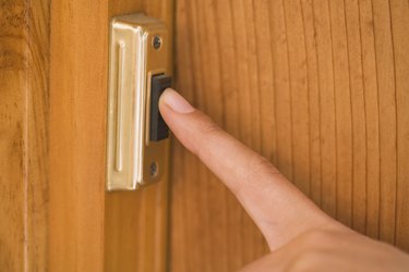 Finger pushing doorbell