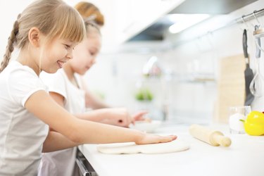 Happy mother and daughters cooking