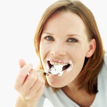 Close-up of a young woman eating dessert