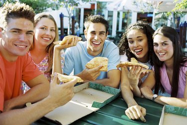 Teens eating pizza