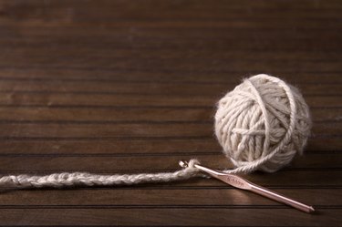 Ball of cream yarn with crochet hook