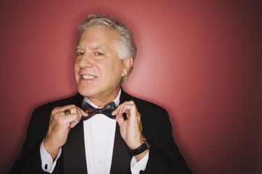 Man adjusting bow tie