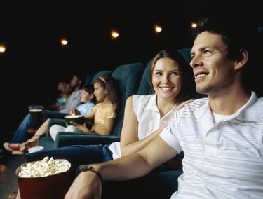 Young couple sitting in a movie theatre