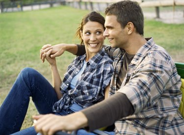 Side view of a young man and a young woman smiling