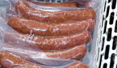 Packaged sausages on display in deli