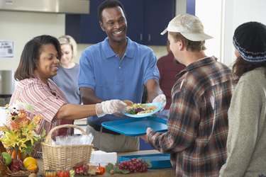 Man and woman helping in soup kitchen