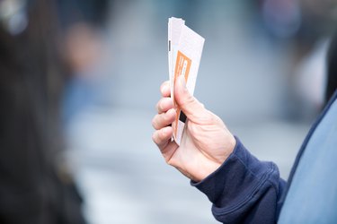 Hand holding tickets