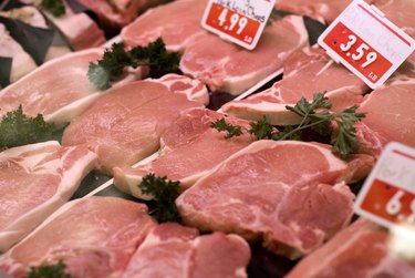 Raw pork chops on display in deli