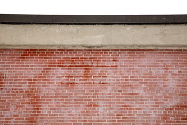 Close-up of brick wall with concrete entablature