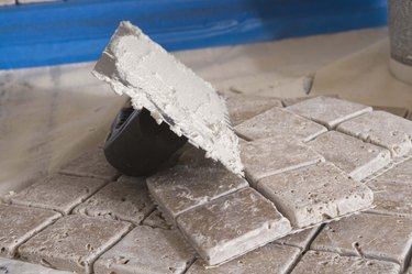 Grout on trowel by tiles