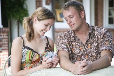 Man giving woman gift at cafe