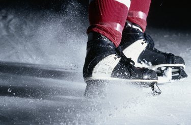 Clouds of ice from abrupt stop by hockey player