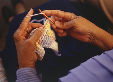 Woman crocheting, close-up of hand