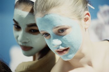 Close-up of two teenage girls wearing facial masks