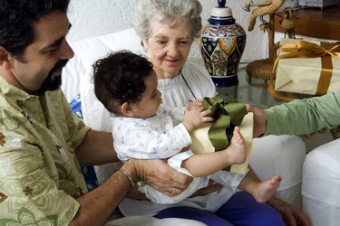 Mature man holding his son and receiving a gift