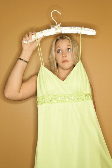 Woman holding dress on hanger